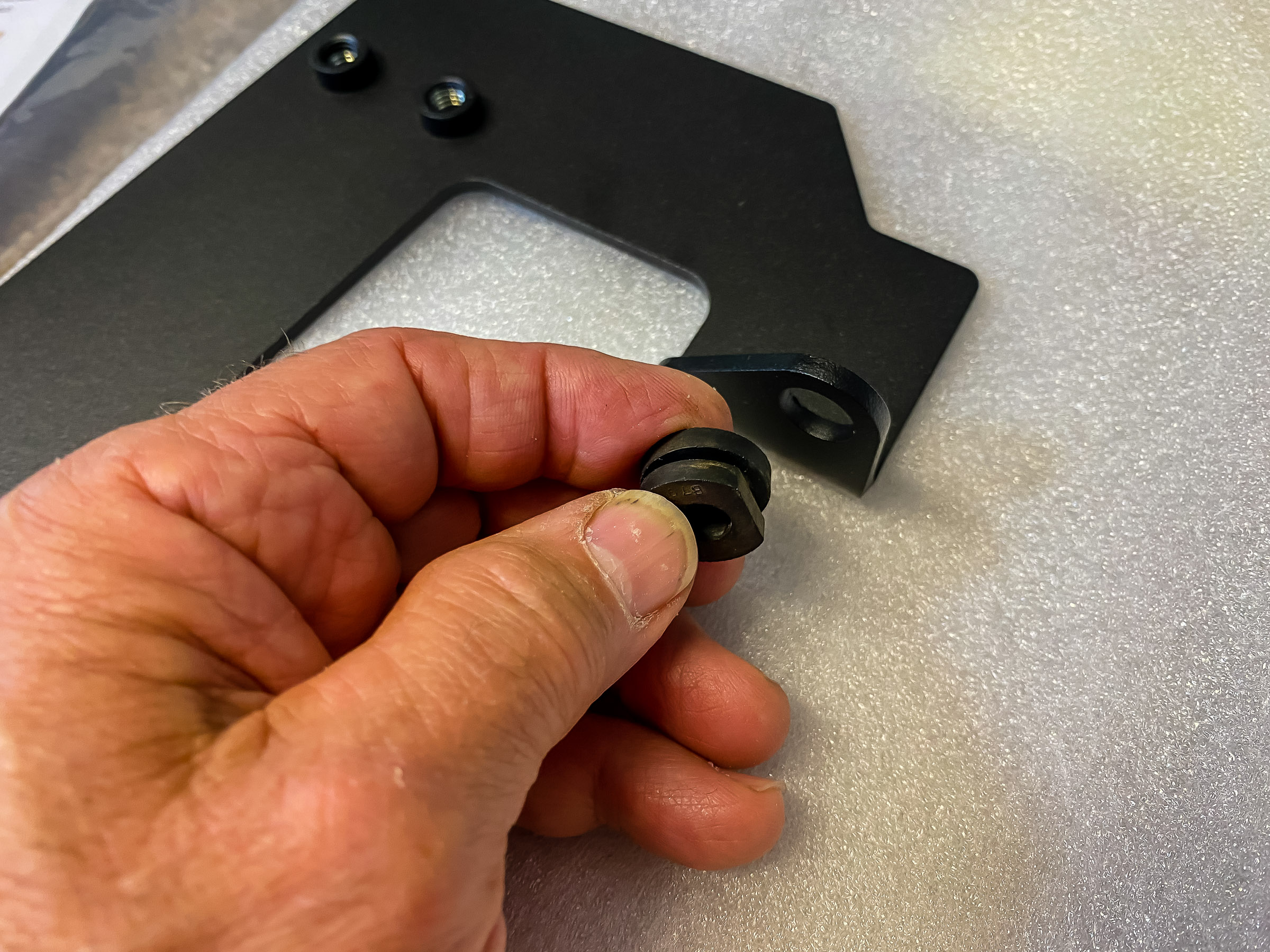 Insert the grommet into the Altrider skid plate bracket.