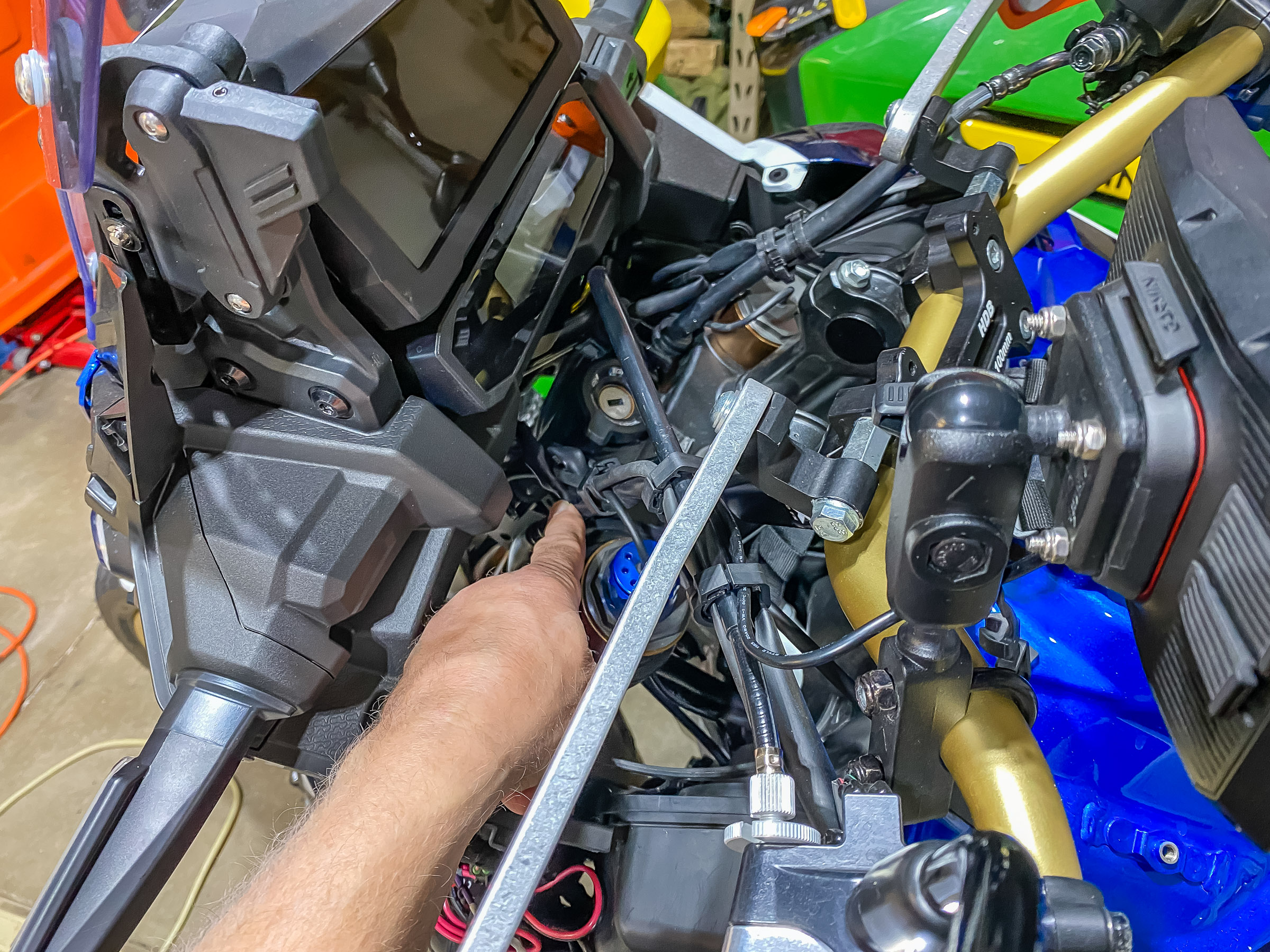 Remove the left plastic fairing. This will expose the wires going to the 12v accessory socket which gets energized when the bike is turned on. I ran the GPS wire down the center with the existing bundle.