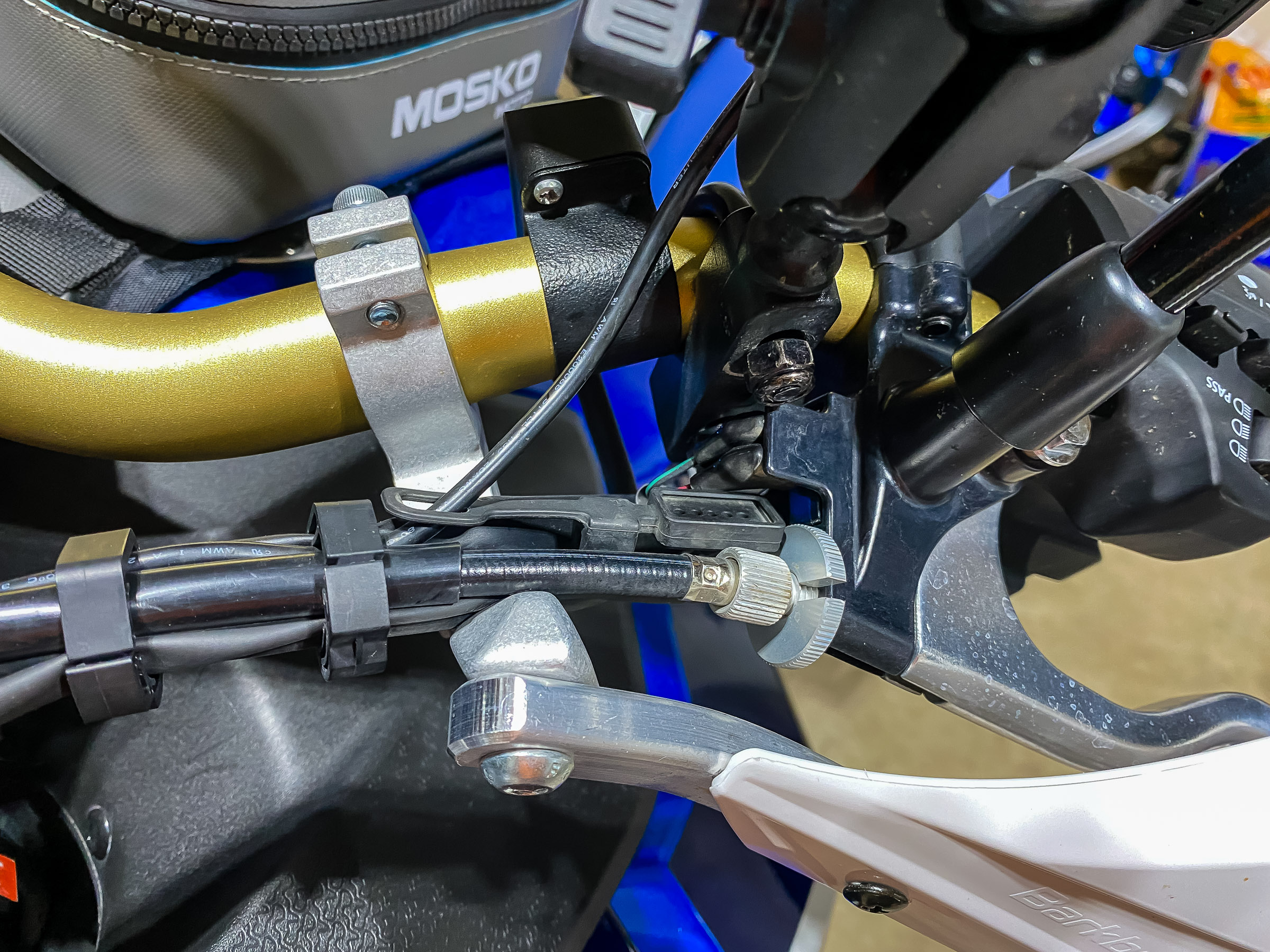 Notice how the bar clamp is under the clutch cable and the wiring harness. Your bike may differ because I have ROX risers on my handlebar. Make sure the clutch cable and wires are not stressed when you turn the handle bar lock to lock.