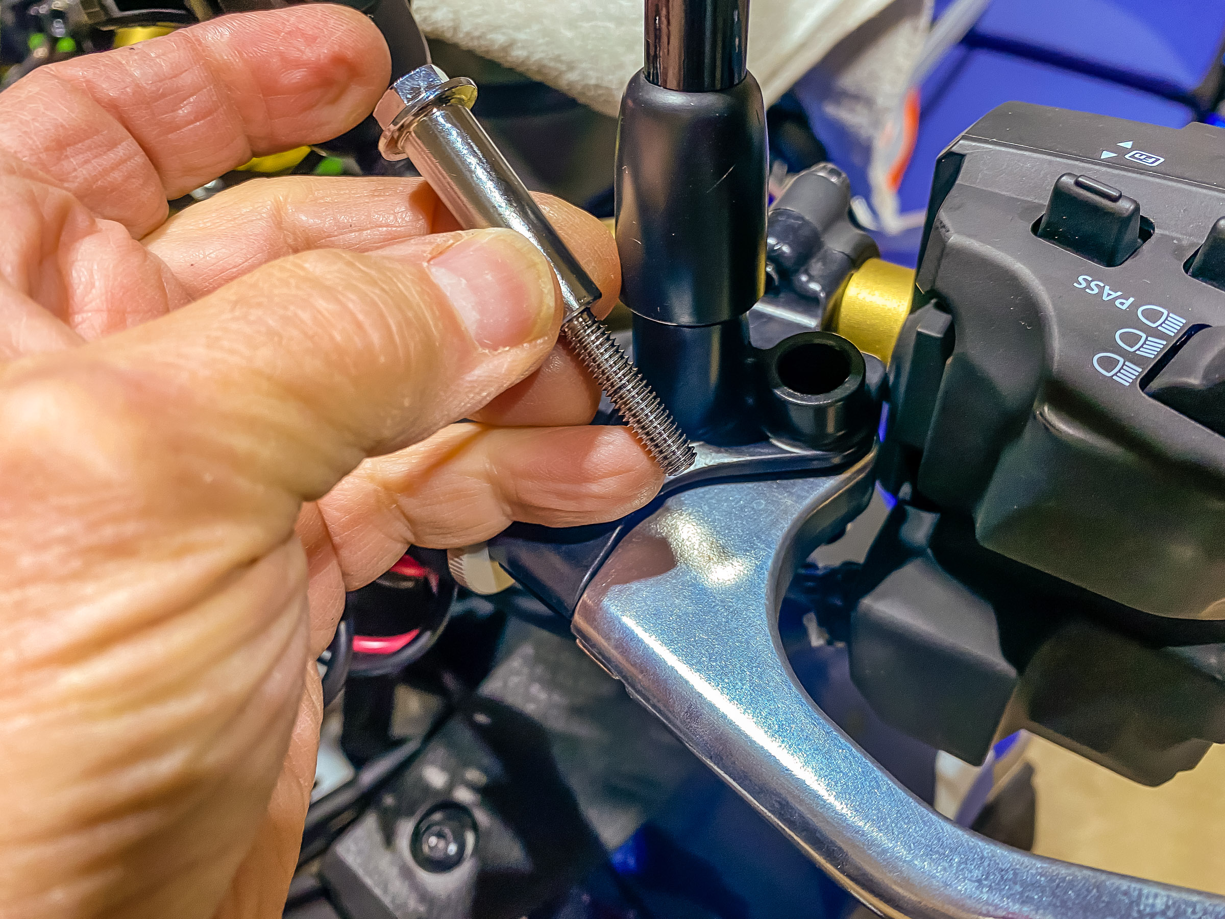 Line up the clutch lever and put the clutch lever pivot bolt back in from the top. Put a little grease on the bolt.