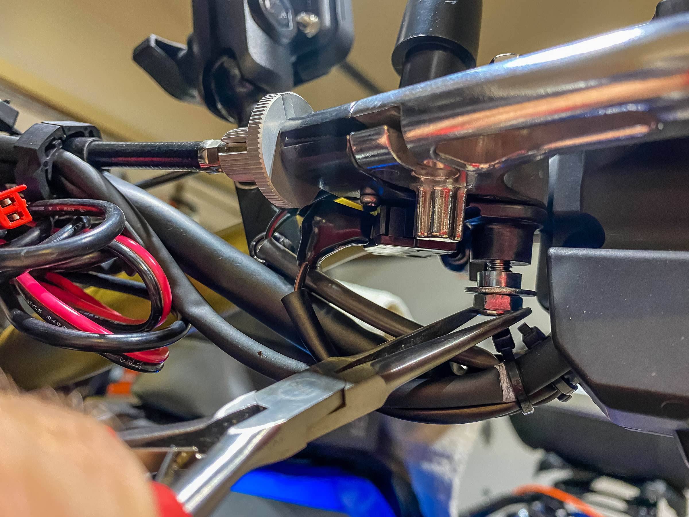 Line up the clutch lever and push the clutch lever pivot bolt down through the clutch lever bushing and tighten the nut to 4.4 ft/lbs. ``