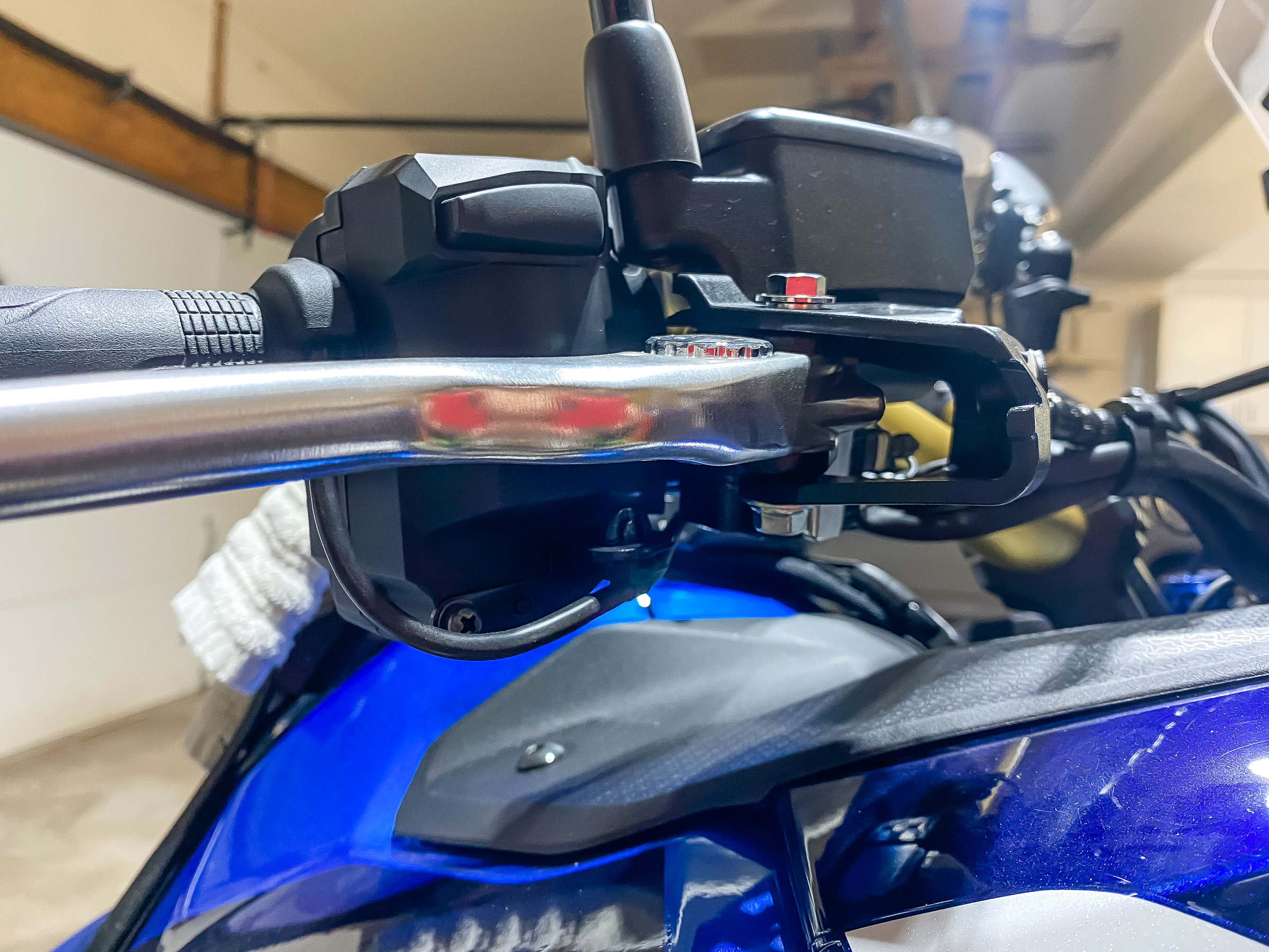 The brake lever pivot pin holds the right side handguard bracket in.