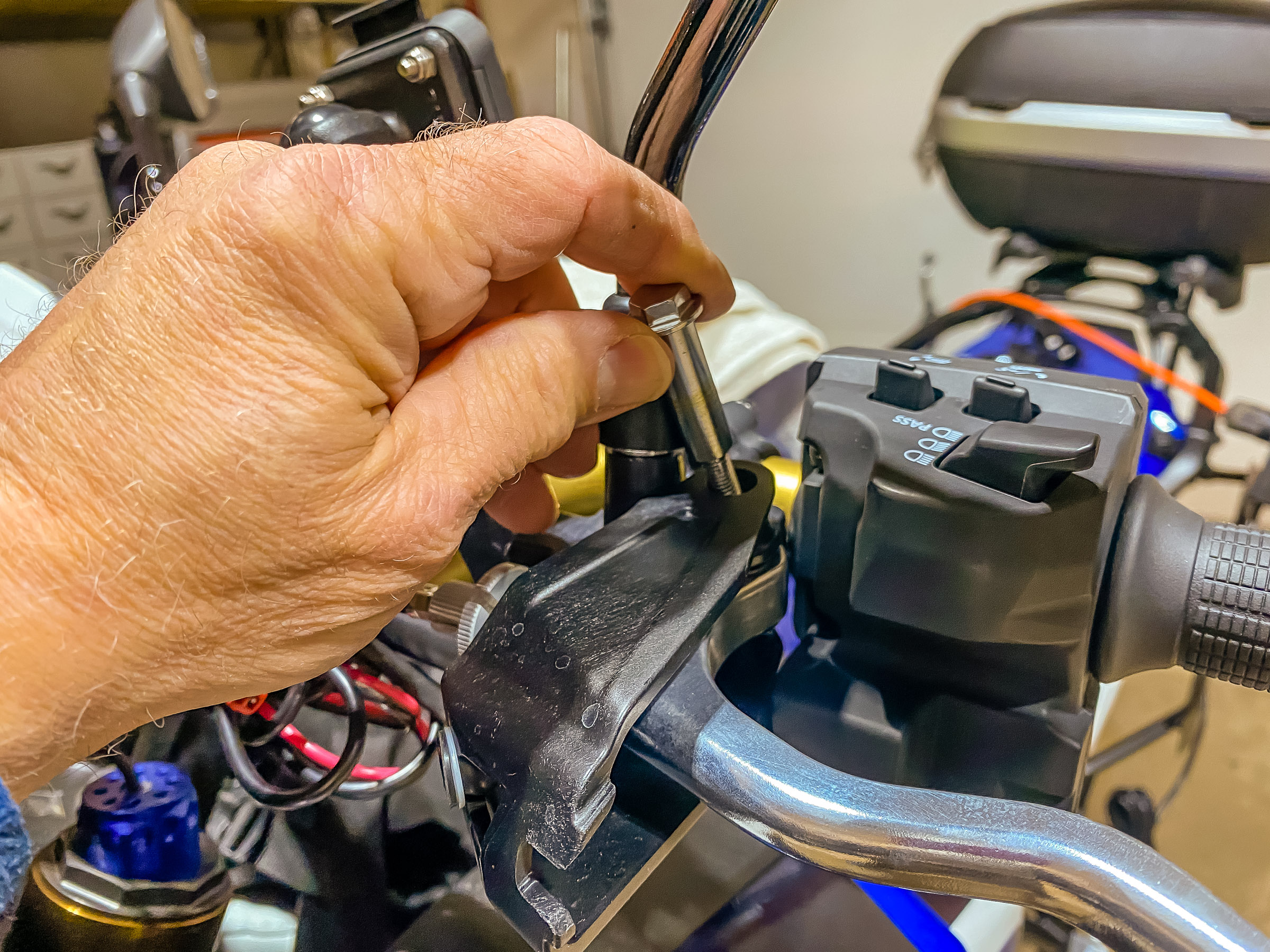 Unscrew and pull out the clutch lever pivot bolt from the  top.