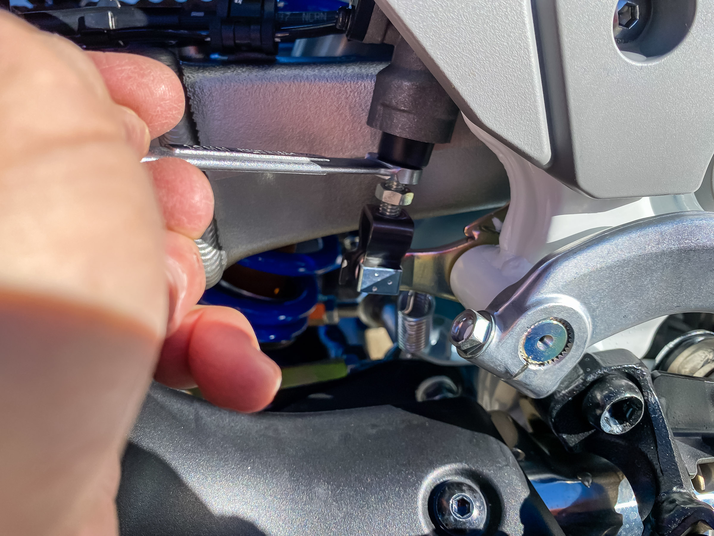 Adjust the bolt to raise or lower the pedal height.