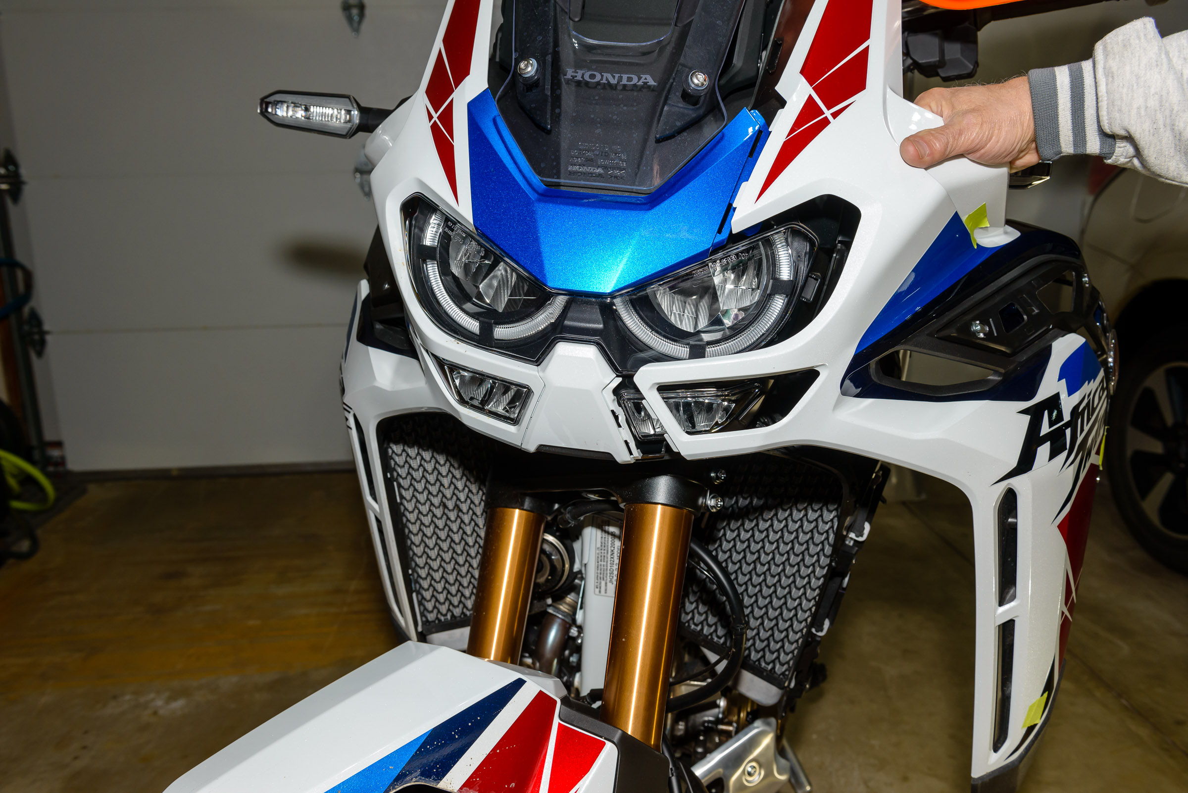 Carefully pull the plastic away from the center of the bike and out of the top slots.