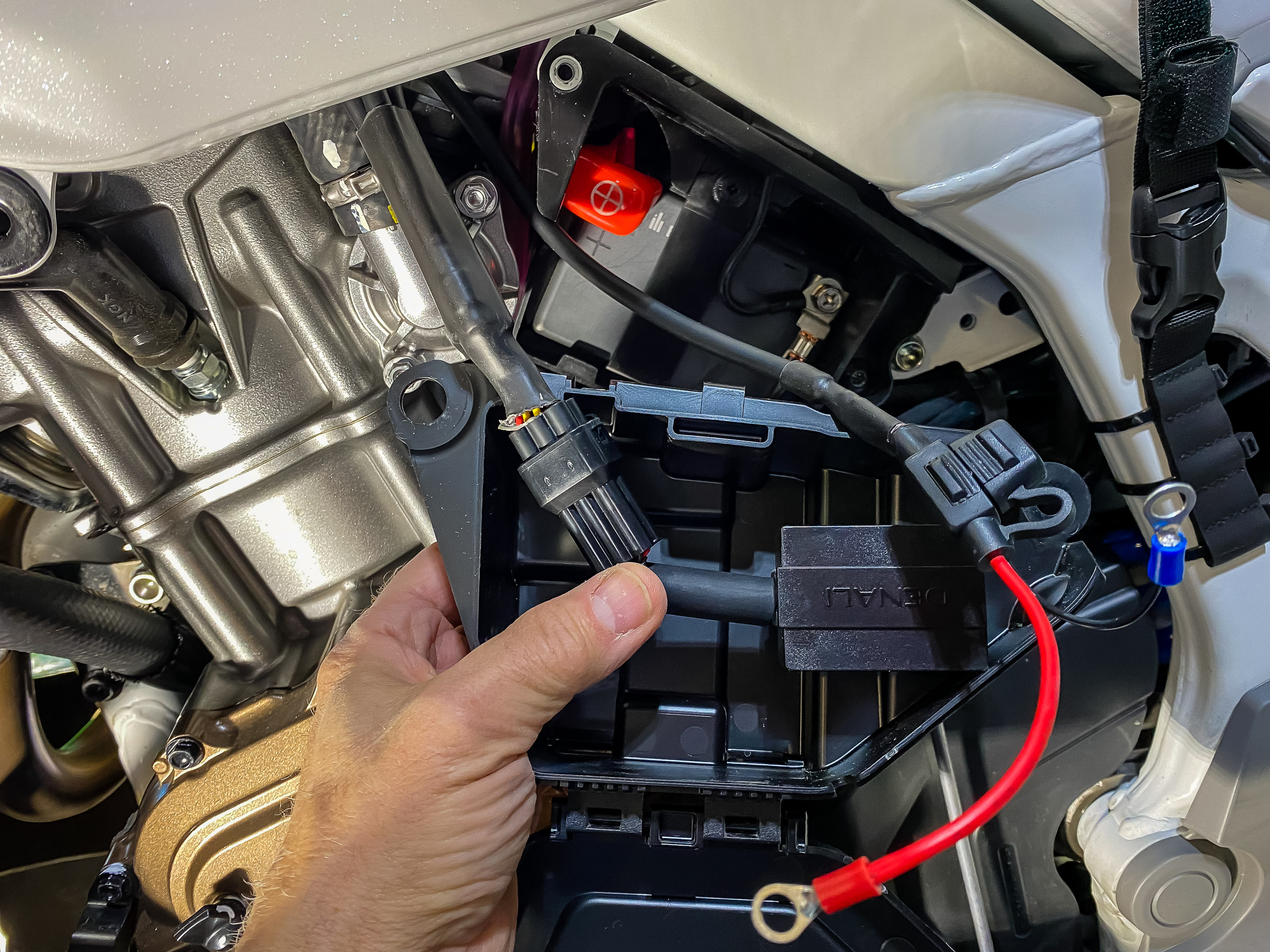 The DataDim module easily fits in the plastic tool box  in front of the battery.