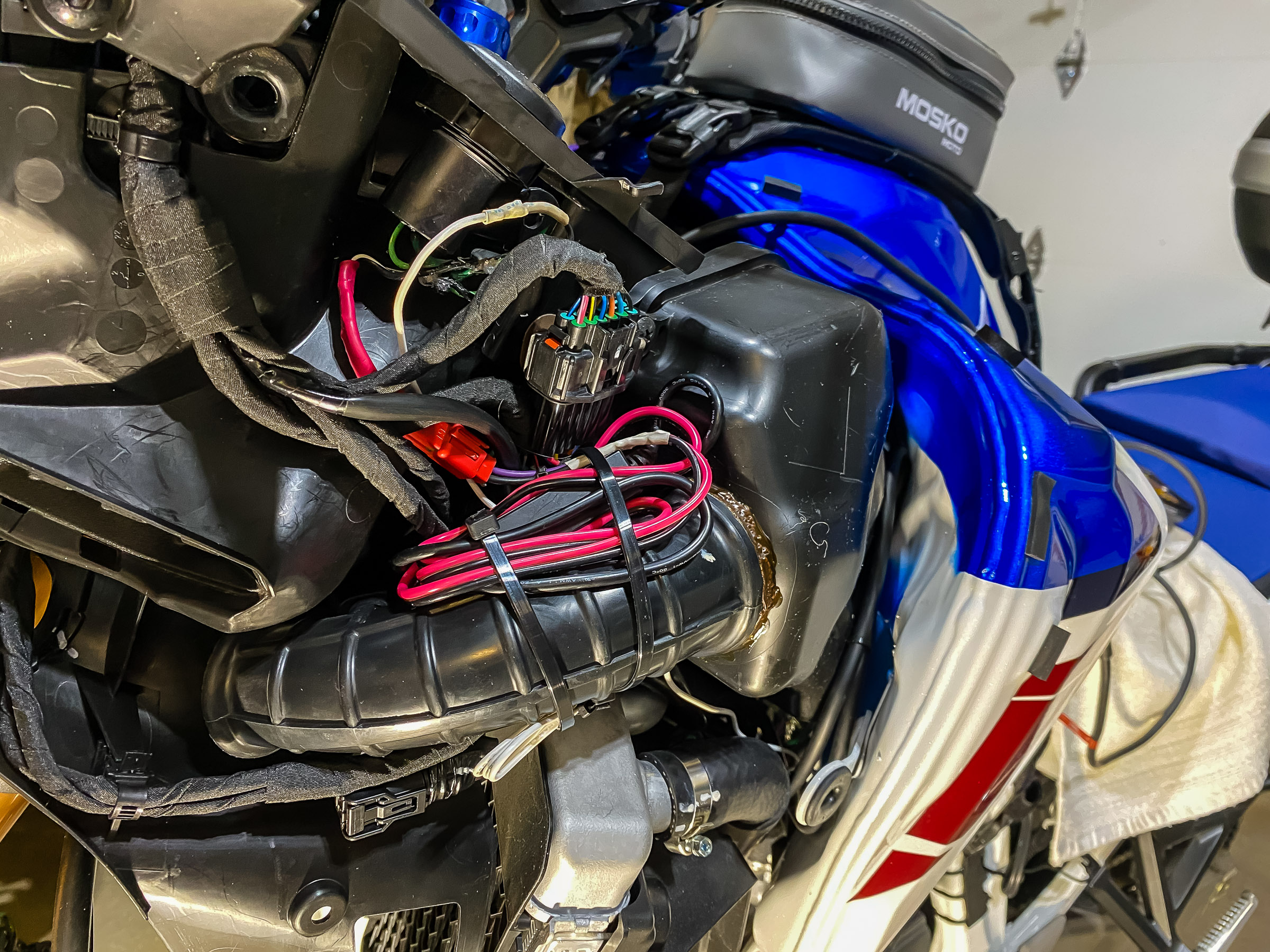 Tie the wires up with cable ties so they're neat. I don't want anything to get in the way of putting the fairing back on. It turned out that the black and red wires from the Garmin GPS got in the way of putting the fairing back on. I had to tuck them under the gas tank on the right.