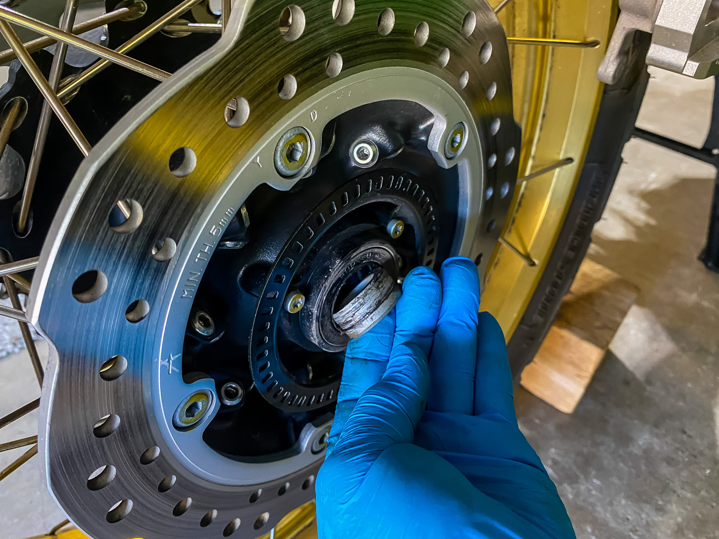 When you bring a wheel in for a tire  change you want to remove anything that can fall off and get lost. This includes the wheel spacers and the sprocket. This is the right side wheel spacer.