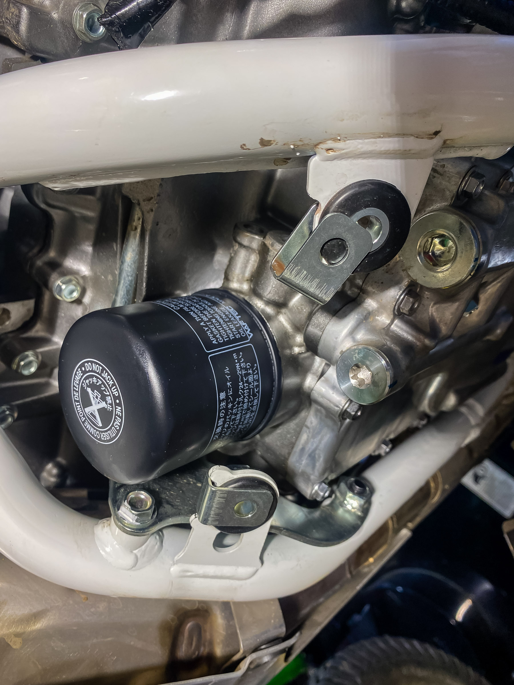 Place the spacers and the U threaded inserts in place over the 2 screws next to the oil filter. Raise the plate up and screw  these in. leave them loose.