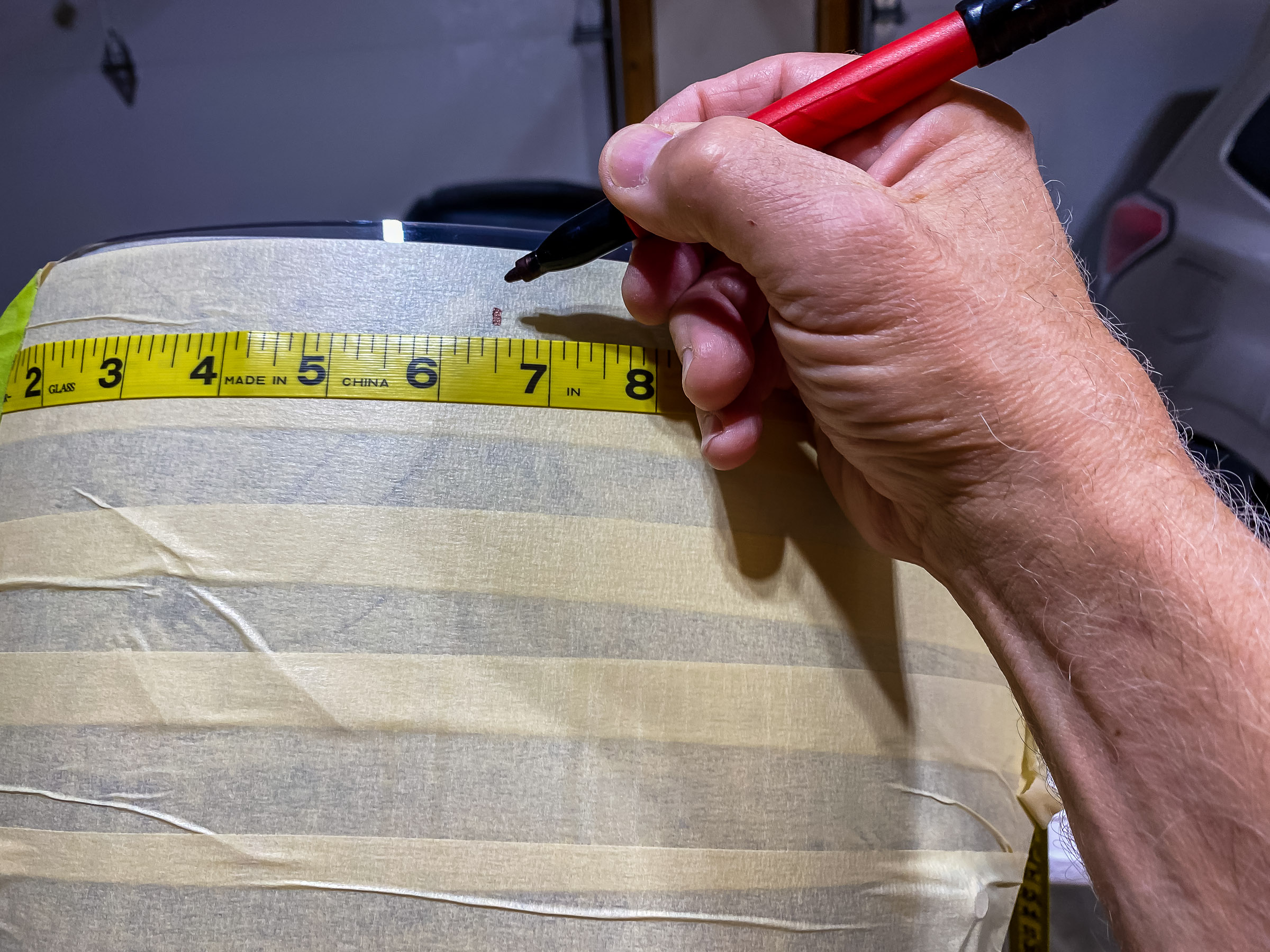 Establish a top center point with a soft tape that will follow the curve.