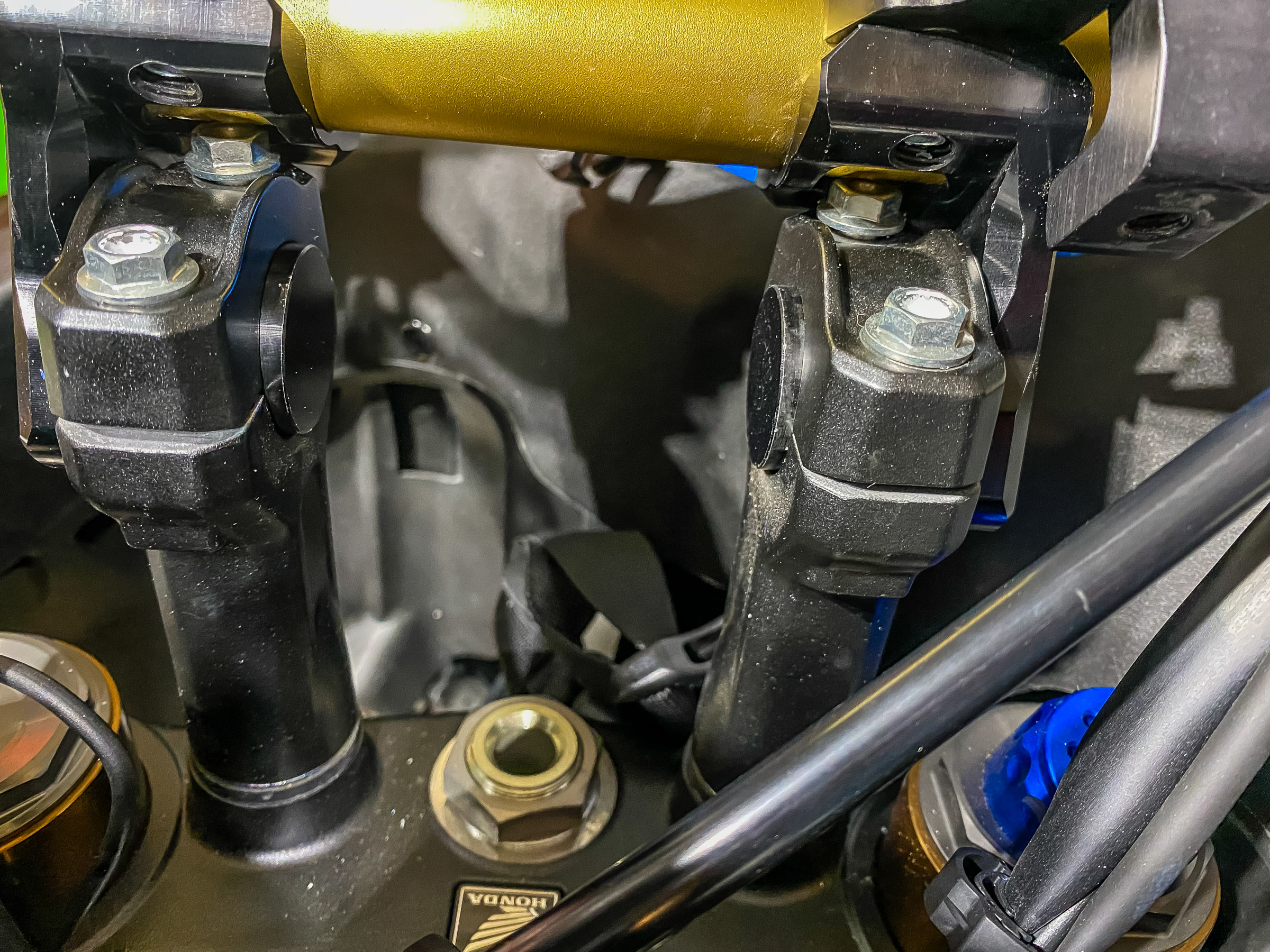 Place the ROX  riser shafts in the existing Honda risers. Place the Honda clamps over them. Put Locktite blue on the Honda screws and run the screws in. Don't tighten. Note that the Honda clamps will tighten around the riser shafts while the ROX clamps won't.