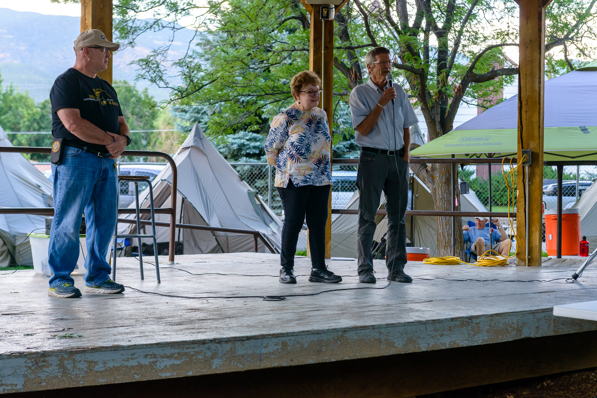 Bob Bushta introducing 2 Paonia city council members at the closing ceremony.